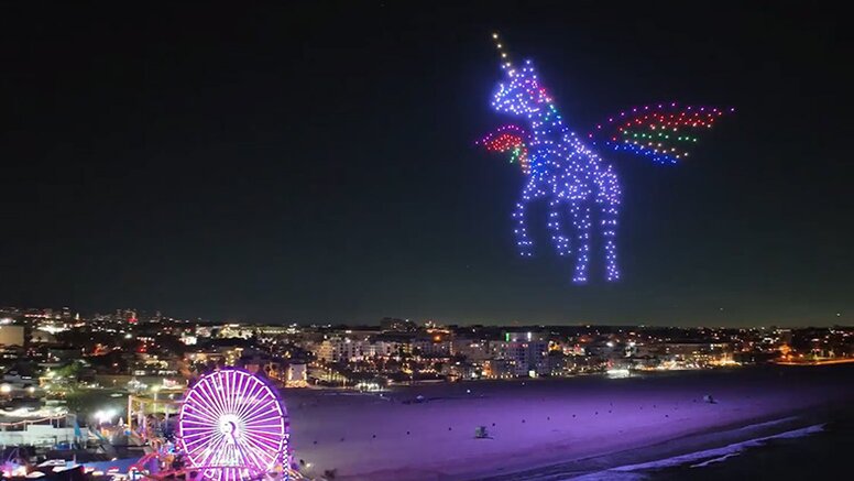 A picture of a drone light show over the Santa Monica pier featuring a unicorn