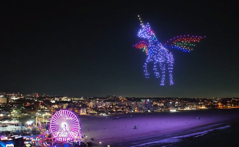 A picture of a drone light show over the Santa Monica pier featuring a unicorn